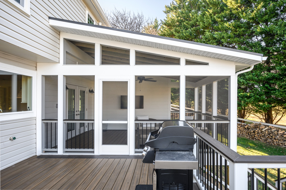 Photo of a mid-sized transitional backyard verandah in DC Metro with a roof extension and mixed railing.