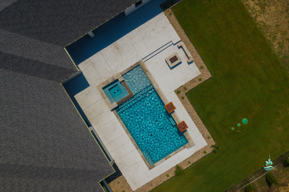 Example of a huge mid-century modern backyard rectangular natural and privacy pool design in Dallas with decking