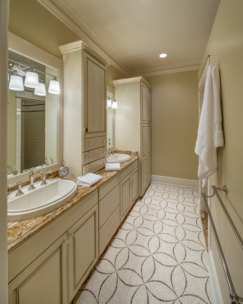 Design ideas for a traditional bathroom in Grand Rapids with a drop-in sink, raised-panel cabinets, an open shower, white cabinets, granite benchtops and beige tile.