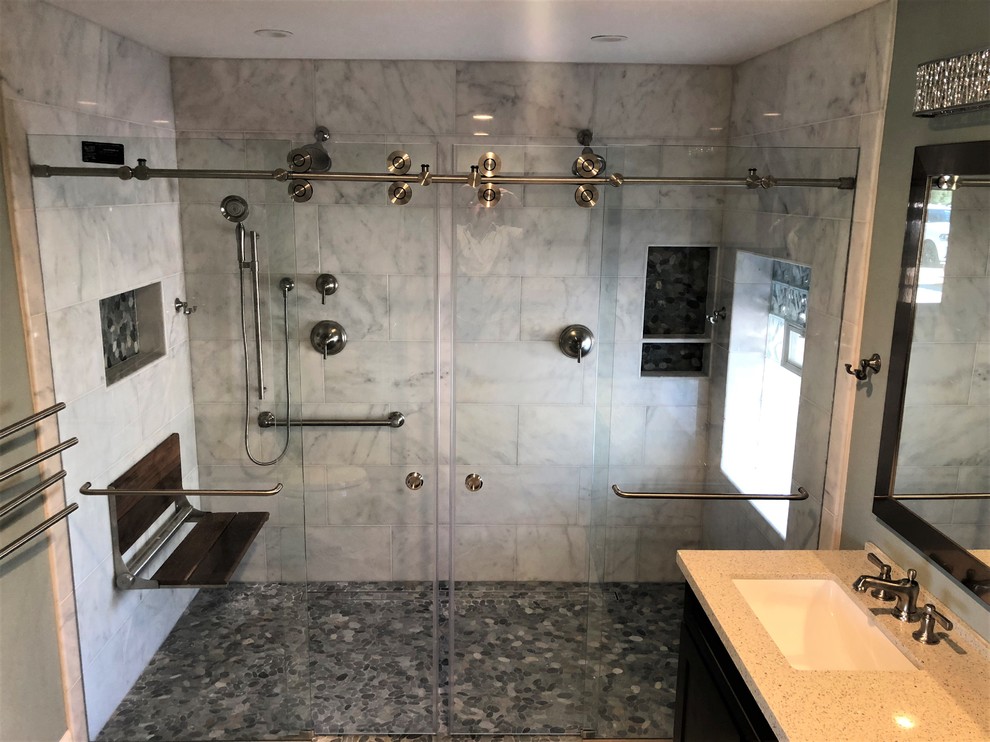 Large contemporary master bathroom in Las Vegas with black cabinets, a double shower, gray tile, marble, grey walls, an undermount sink, engineered quartz benchtops, a sliding shower screen and beige benchtops.
