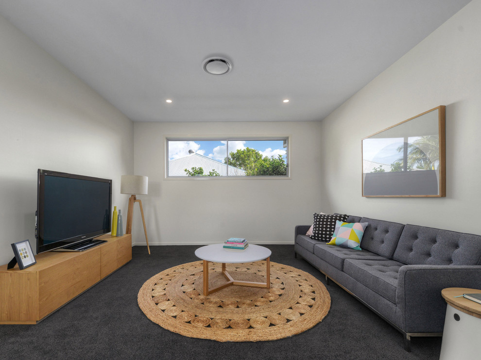 Design ideas for a transitional enclosed living room in Brisbane with white walls, carpet and a freestanding tv.