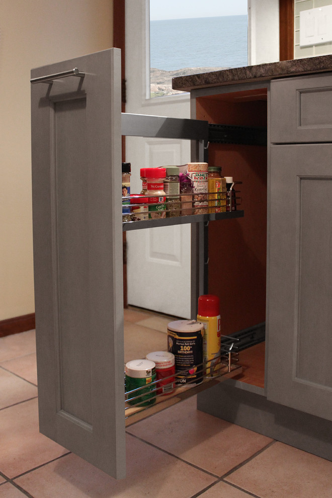 Inspiration for a mid-sized transitional l-shaped ceramic tile eat-in kitchen remodel in Boston with an undermount sink, shaker cabinets, gray cabinets, granite countertops, gray backsplash, glass tile backsplash, stainless steel appliances and an island