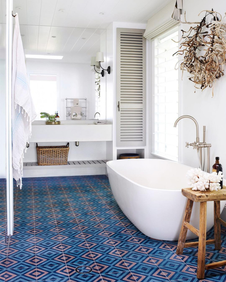This is an example of a beach style bathroom in Sydney with a freestanding tub.