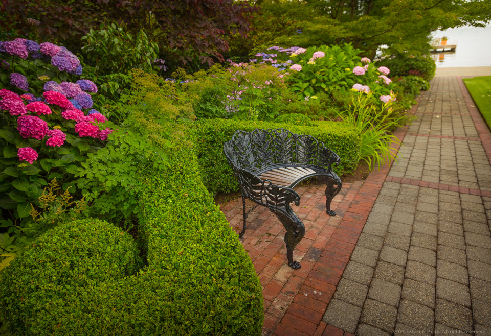 This is an example of a large traditional backyard formal garden in Seattle with brick pavers.