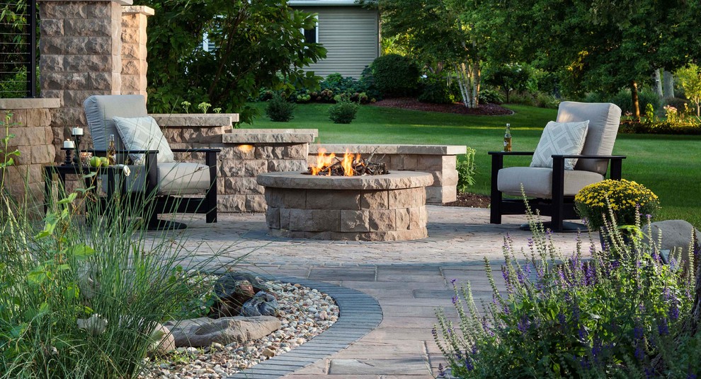 Photo of a transitional patio in Other with a fire feature, natural stone pavers and no cover.