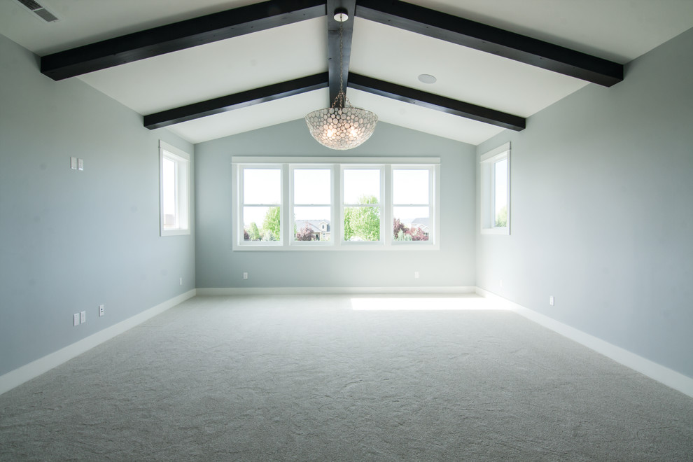 Expansive arts and crafts master bedroom in Other with blue walls, carpet and grey floor.