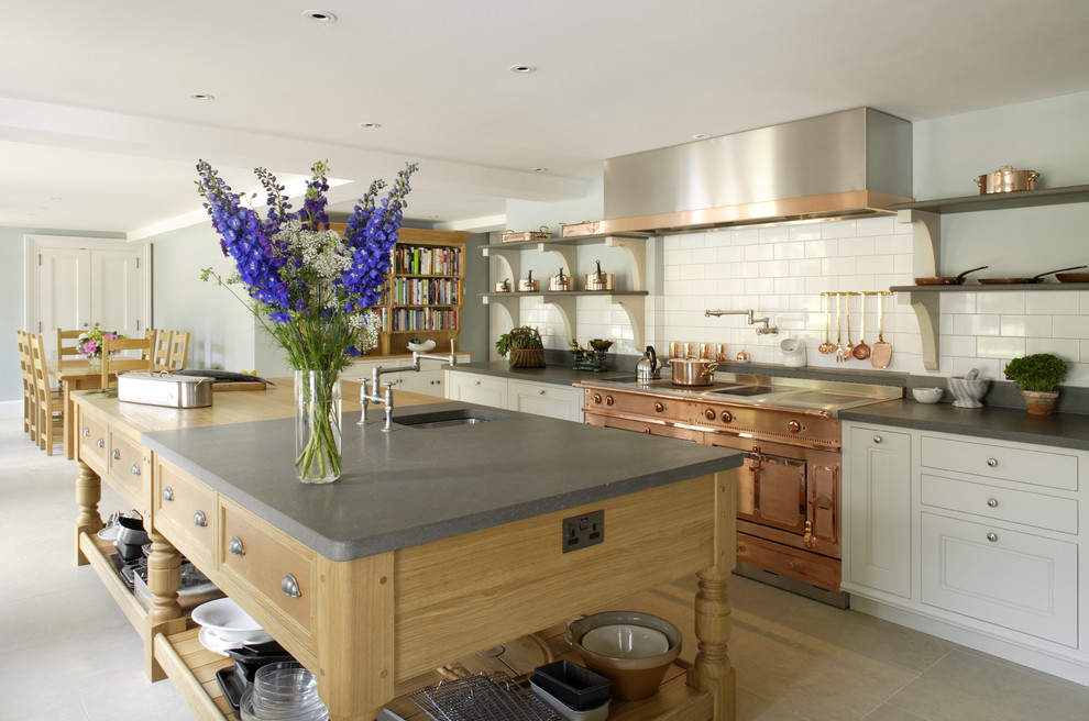 Large transitional l-shaped separate kitchen in Hampshire with a drop-in sink, recessed-panel cabinets, wood benchtops, white splashback, subway tile splashback, coloured appliances, limestone floors and with island.