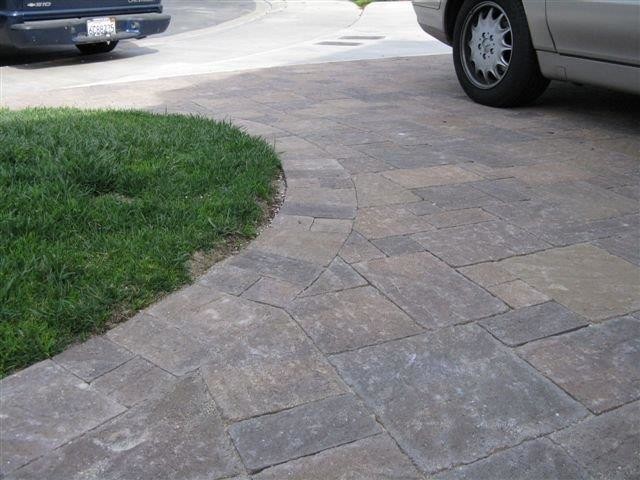 Design ideas for a small traditional front yard driveway for summer in Orange County with concrete pavers.