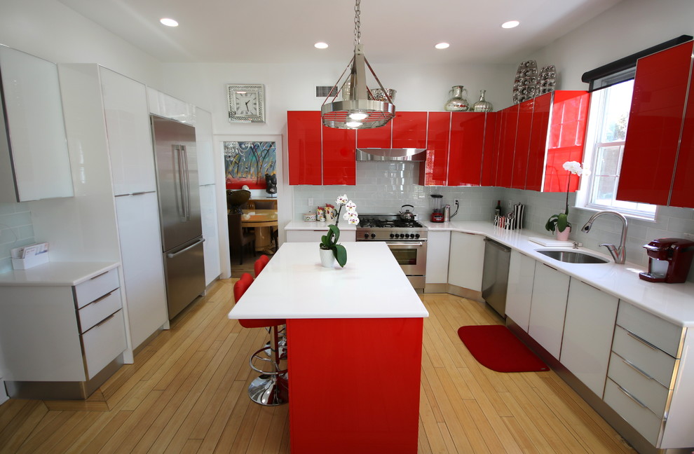 Inspiration for a mid-sized contemporary eat-in kitchen in New York with a drop-in sink, flat-panel cabinets, red cabinets, quartz benchtops, blue splashback, ceramic splashback, stainless steel appliances, light hardwood floors, with island and brown floor.