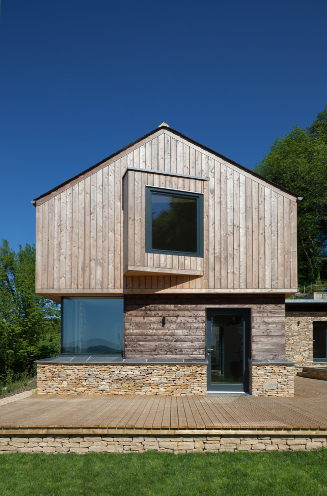 Inspiration for a mid-sized contemporary two-storey exterior in Gloucestershire with mixed siding and a gable roof.
