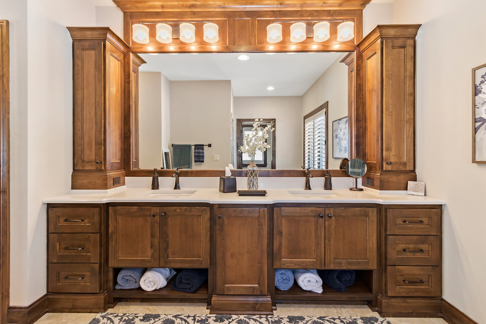 Large country bathroom in Charleston with recessed-panel cabinets, dark wood cabinets, an alcove shower, beige tile, ceramic tile, beige walls, ceramic floors, an undermount sink, beige floor, a hinged shower door and beige benchtops.