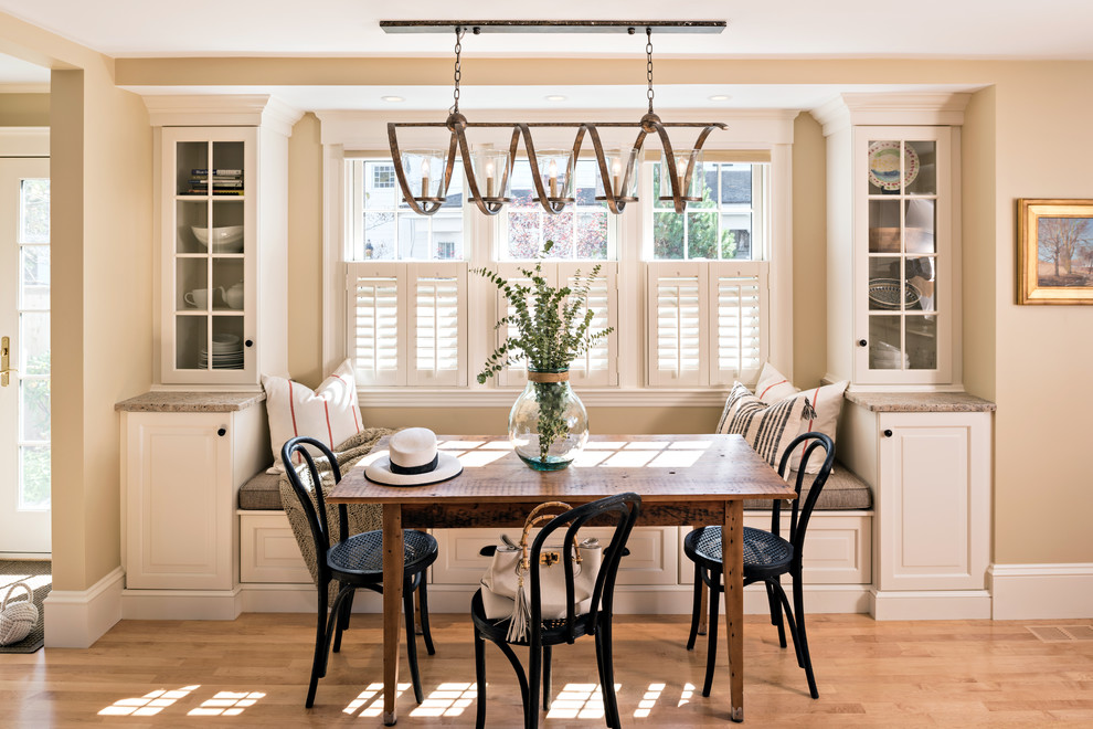 Inspiration for a transitional kitchen/dining combo in Boston with beige walls, light hardwood floors and brown floor.