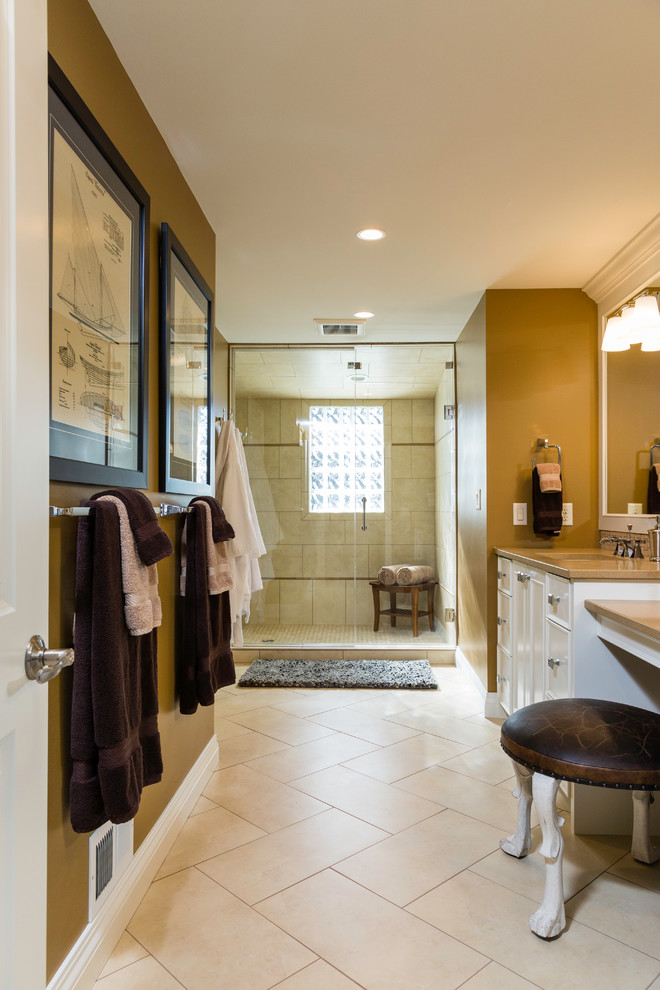 Large transitional master bathroom in Other with raised-panel cabinets, dark wood cabinets, a one-piece toilet, blue walls, porcelain floors, solid surface benchtops and beige floor.