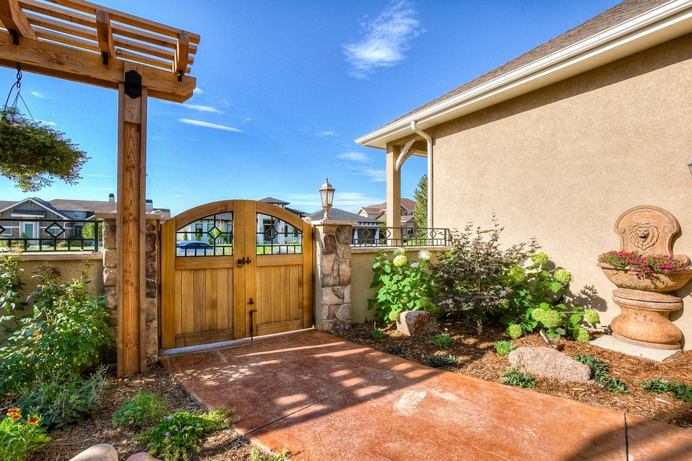 Inspiration for a mid-sized transitional partial sun front yard stone walkway in Denver.