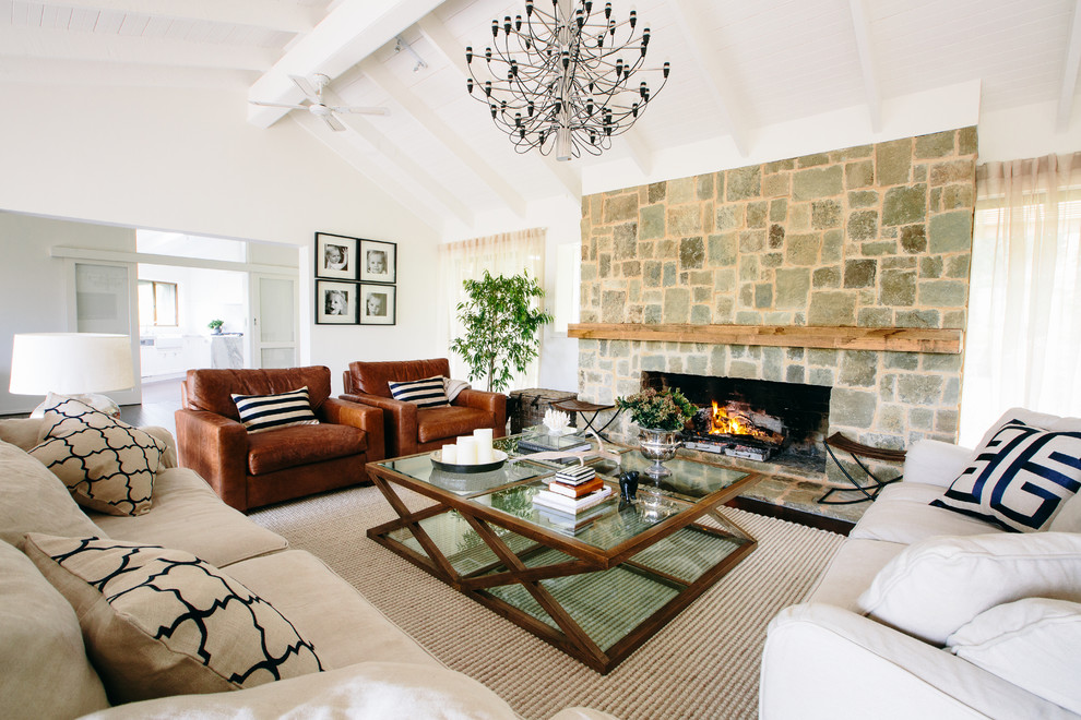 Mid-sized mediterranean open concept living room in Melbourne with a stone fireplace surround, white walls and a standard fireplace.