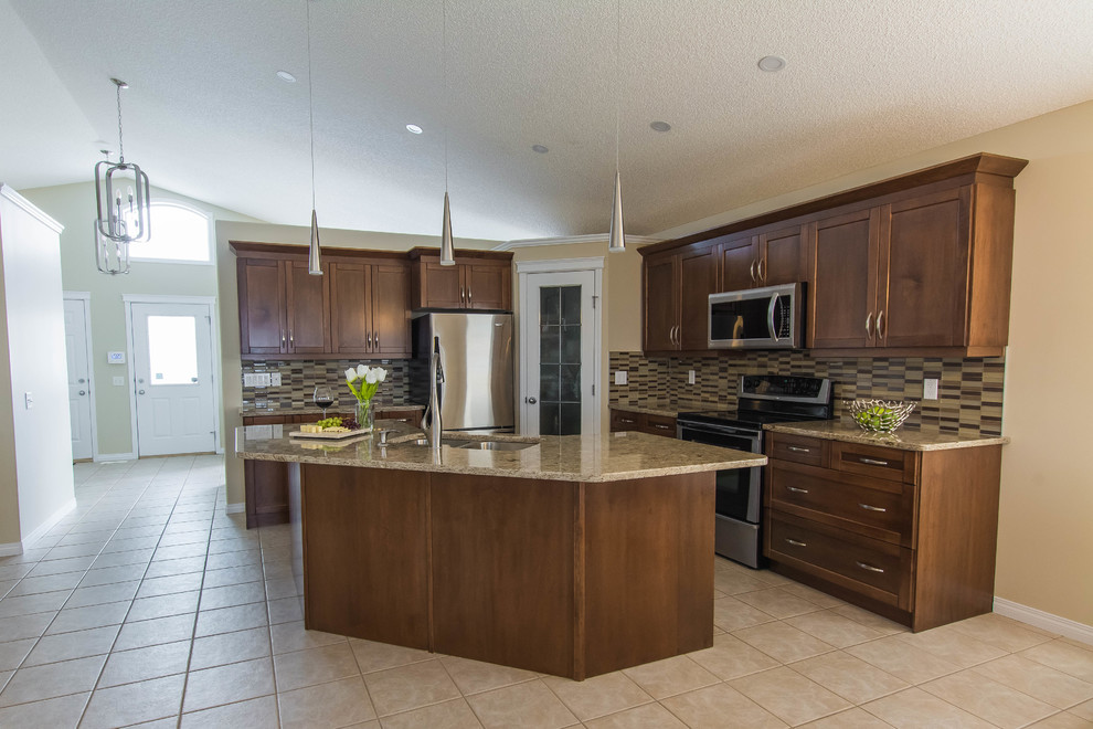Eat-in kitchen - mid-sized transitional l-shaped ceramic tile and beige floor eat-in kitchen idea in Edmonton with a double-bowl sink, shaker cabinets, brown cabinets, quartz countertops, beige backsplash, glass tile backsplash, stainless steel appliances and an island