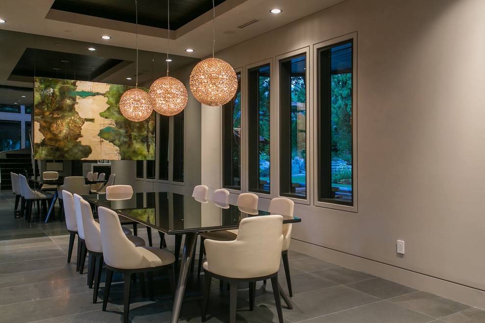 This is an example of a large modern separate dining room in Vancouver with white walls, ceramic floors and no fireplace.