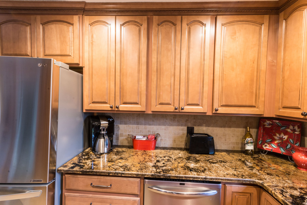 Eat-in kitchen - mid-sized u-shaped cement tile floor and beige floor eat-in kitchen idea with an undermount sink, raised-panel cabinets, medium tone wood cabinets, granite countertops, stainless steel appliances, no island and brown countertops