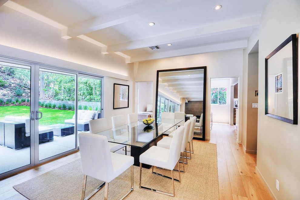 Photo of a contemporary dining room in Los Angeles with beige walls and medium hardwood floors.