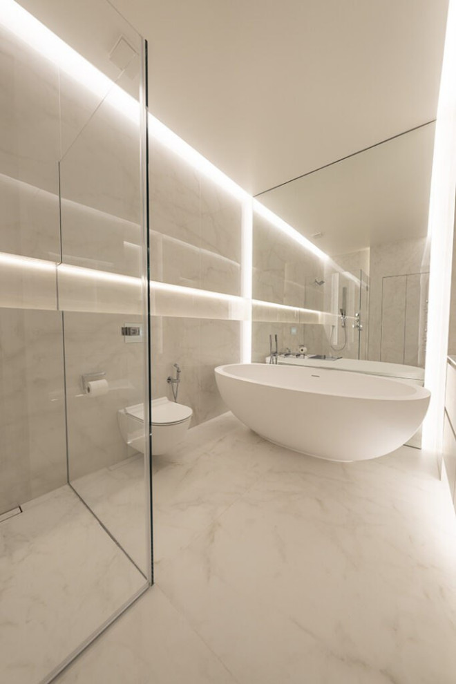 Inspiration for a large modern master bathroom in London with open cabinets, white cabinets, a drop-in tub, a shower/bathtub combo, a bidet, white tile, glass tile, white walls, ceramic floors, a drop-in sink, stainless steel benchtops, white floor, a hinged shower door, grey benchtops, a single vanity, a floating vanity, wood and decorative wall panelling.