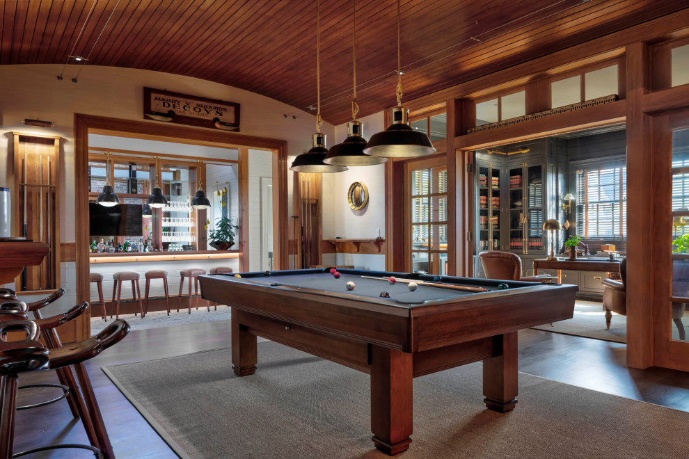 This is an example of a classic enclosed games room in Baltimore with a game room, a home bar, white walls, medium hardwood flooring, brown floors, a wood ceiling, tongue and groove walls and wainscoting.