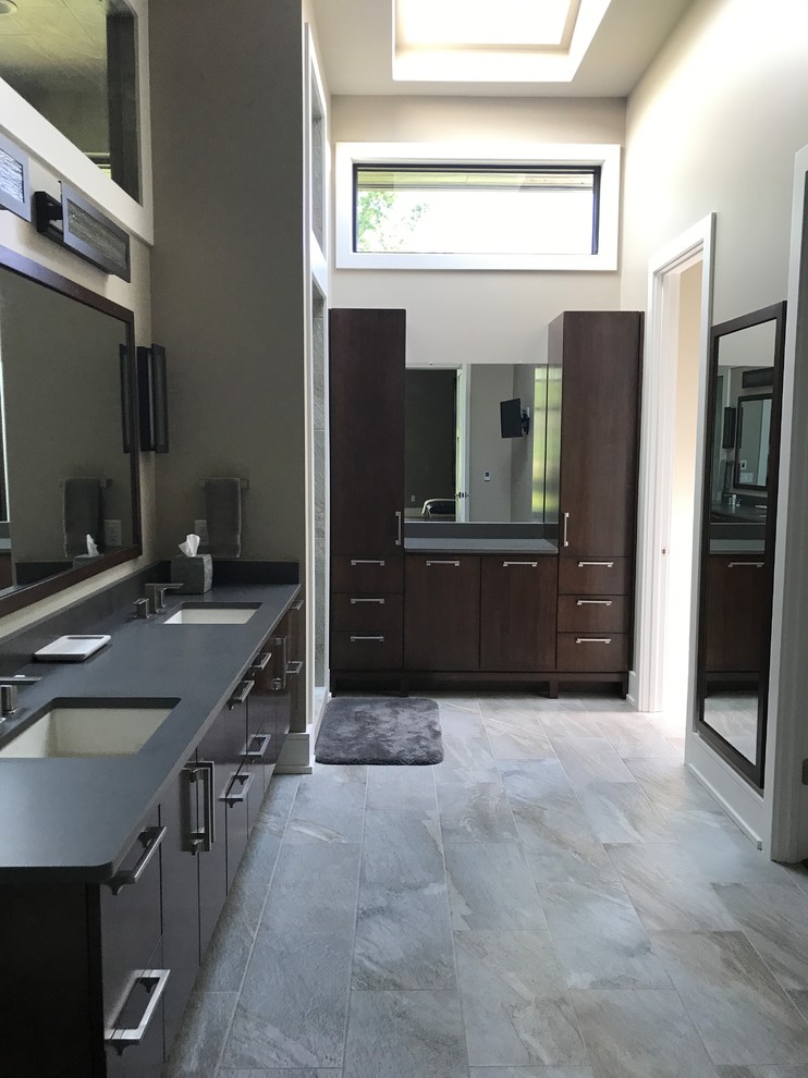 Mid-sized contemporary master wet room bathroom in Other with flat-panel cabinets, dark wood cabinets, a freestanding tub, gray tile, stone tile, beige walls, slate floors, an undermount sink, engineered quartz benchtops, grey floor and a hinged shower door.