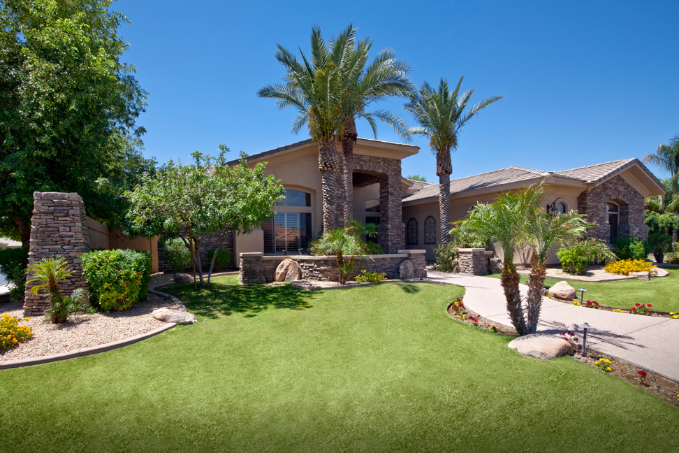 This is an example of a large transitional full sun front yard concrete paver landscaping in Phoenix.