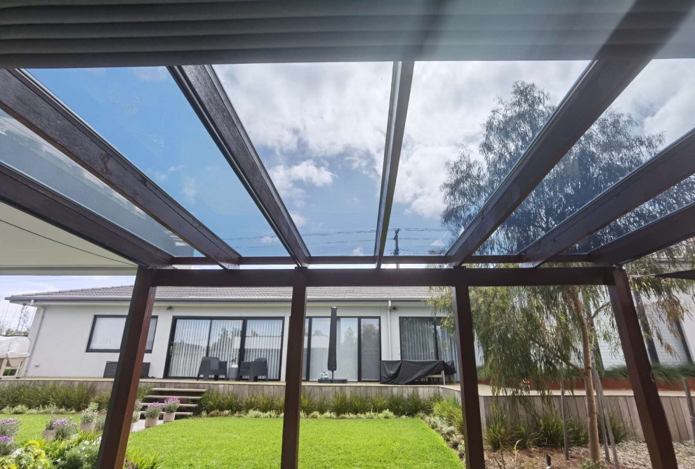 Medium sized modern back patio in Melbourne with an outdoor kitchen, concrete paving and a pergola.