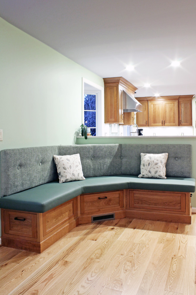 Example of a large transitional u-shaped light wood floor and beige floor open concept kitchen design with an undermount sink, recessed-panel cabinets, light wood cabinets, quartz countertops, green backsplash, mosaic tile backsplash, stainless steel appliances and a peninsula