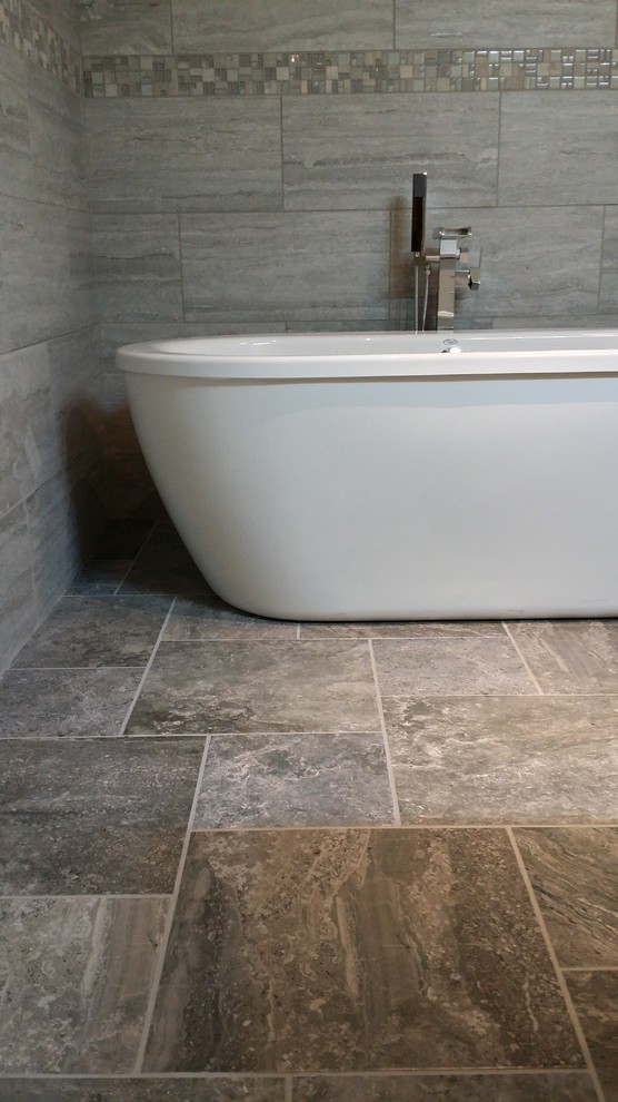 Expansive traditional master bathroom in Seattle with a freestanding tub, an open shower, gray tile, porcelain tile, grey walls and porcelain floors.