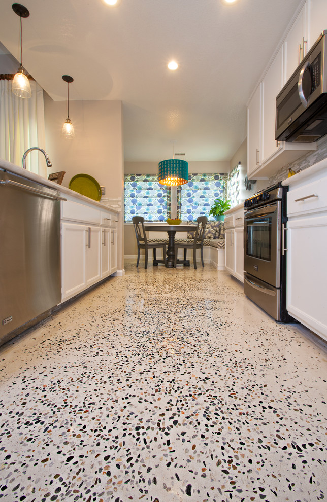 Example of a mid-sized transitional kitchen design in Sacramento with flat-panel cabinets, white cabinets, granite countertops and glass tile backsplash