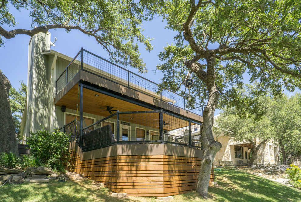 Deck - large rustic backyard balcony deck idea in Austin
