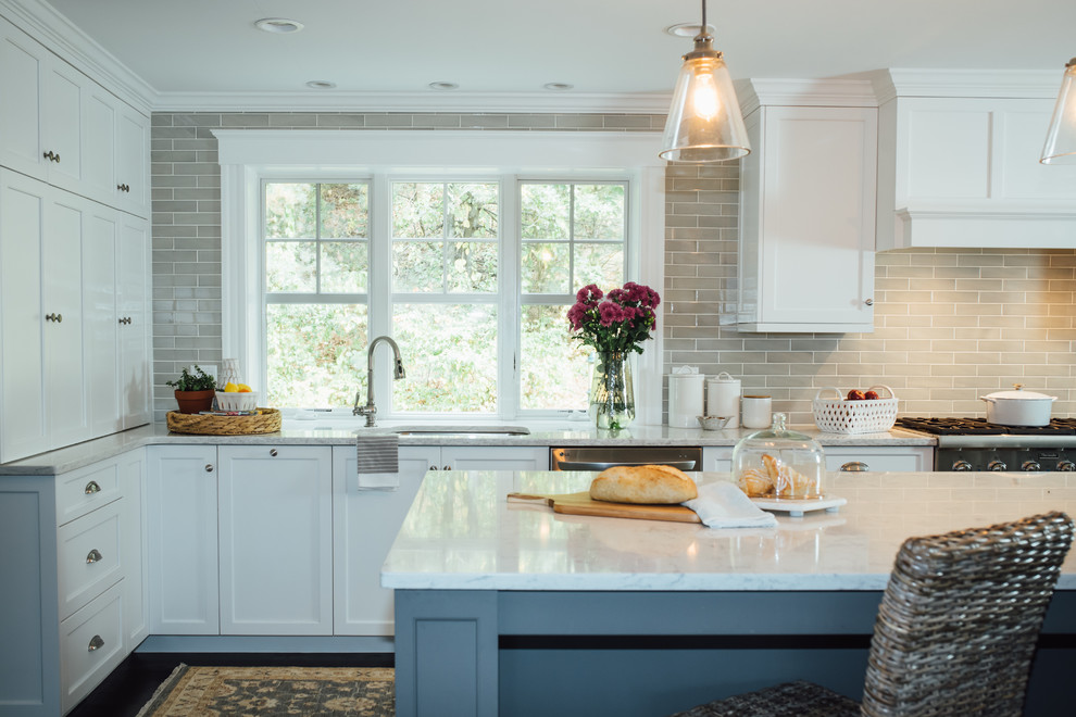 Example of a large classic l-shaped dark wood floor and brown floor open concept kitchen design in Boston with a drop-in sink, shaker cabinets, gray cabinets, quartz countertops, gray backsplash, ceramic backsplash, stainless steel appliances and an island