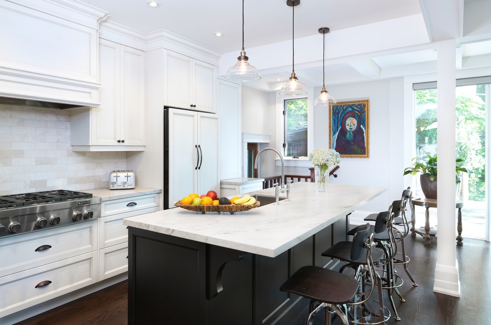This is an example of a mid-sized transitional single-wall eat-in kitchen in Toronto with with island, an undermount sink, white cabinets, beige splashback, dark hardwood floors, recessed-panel cabinets, ceramic splashback, quartz benchtops, panelled appliances, brown floor and white benchtop.