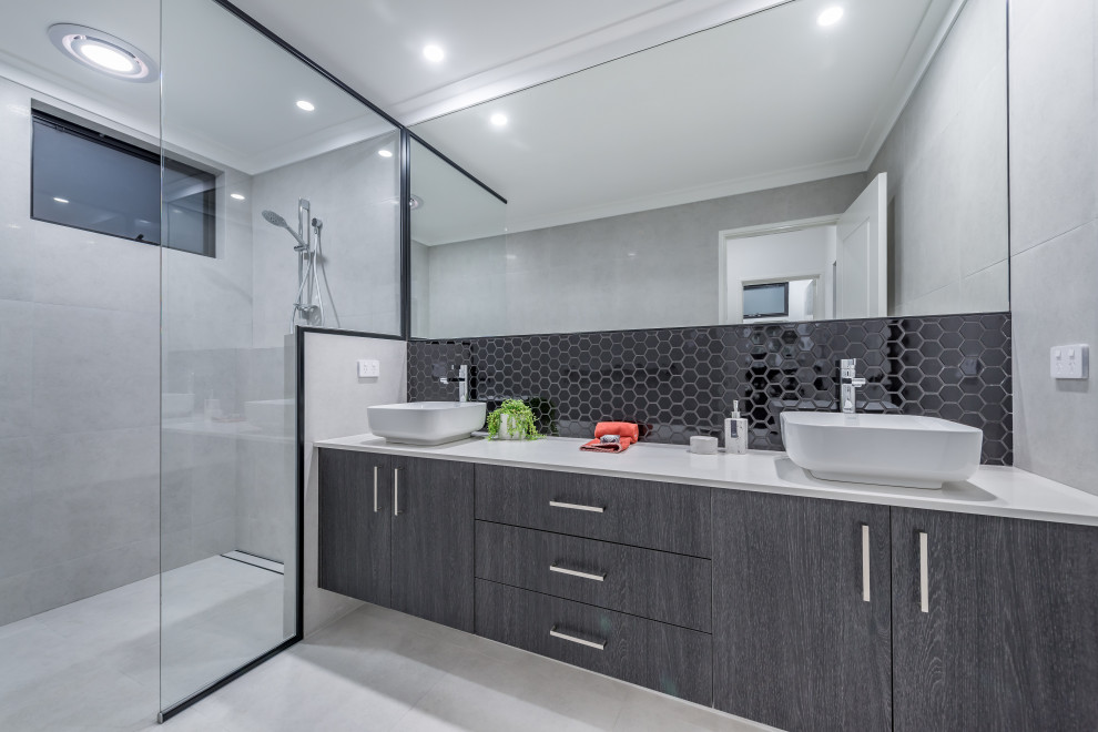Inspiration for a contemporary bathroom in Perth with flat-panel cabinets, grey cabinets, a curbless shower, black tile, mosaic tile, a vessel sink, grey floor, an open shower, white benchtops, a double vanity and a floating vanity.
