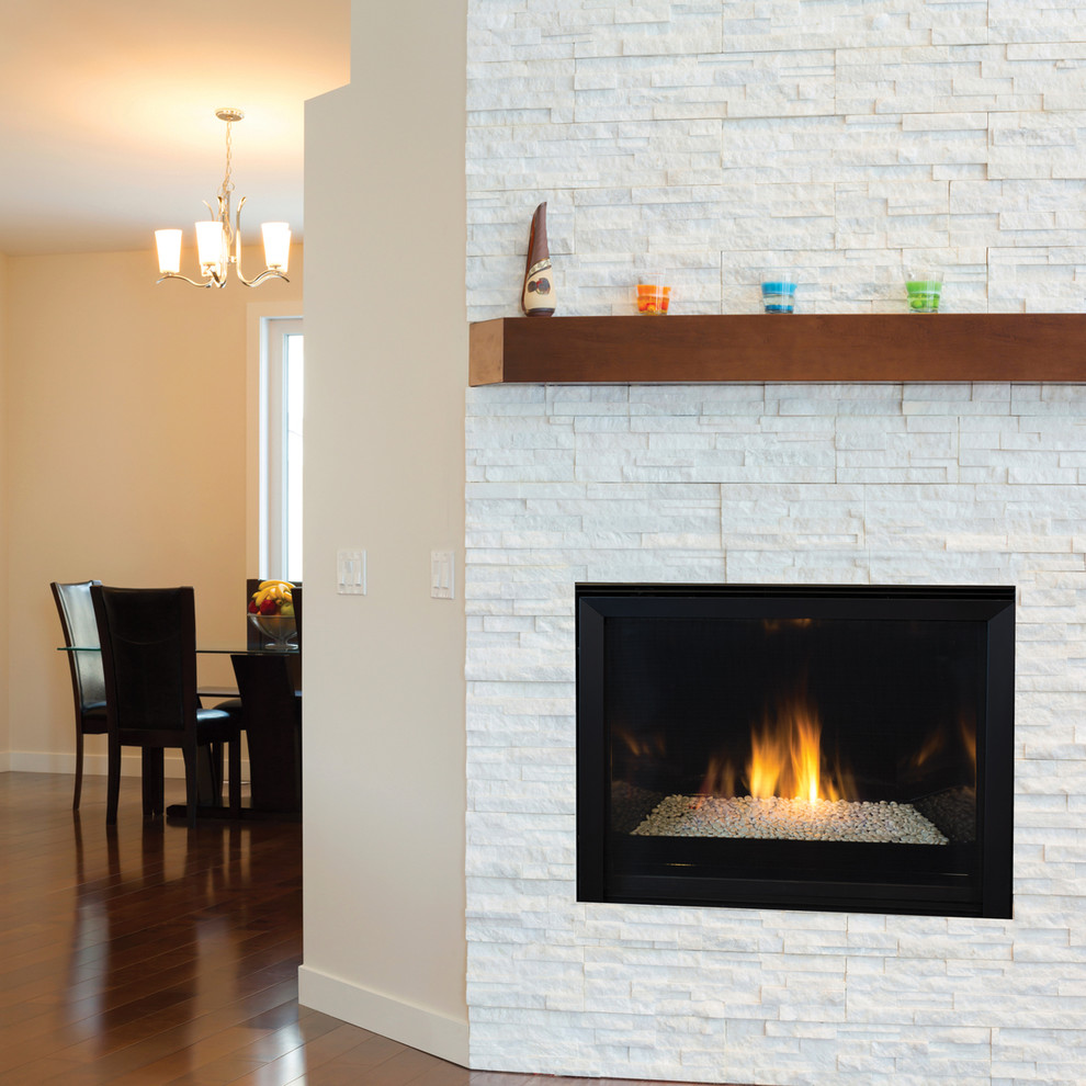 This is an example of a contemporary living room in Orange County with a standard fireplace and a brick fireplace surround.