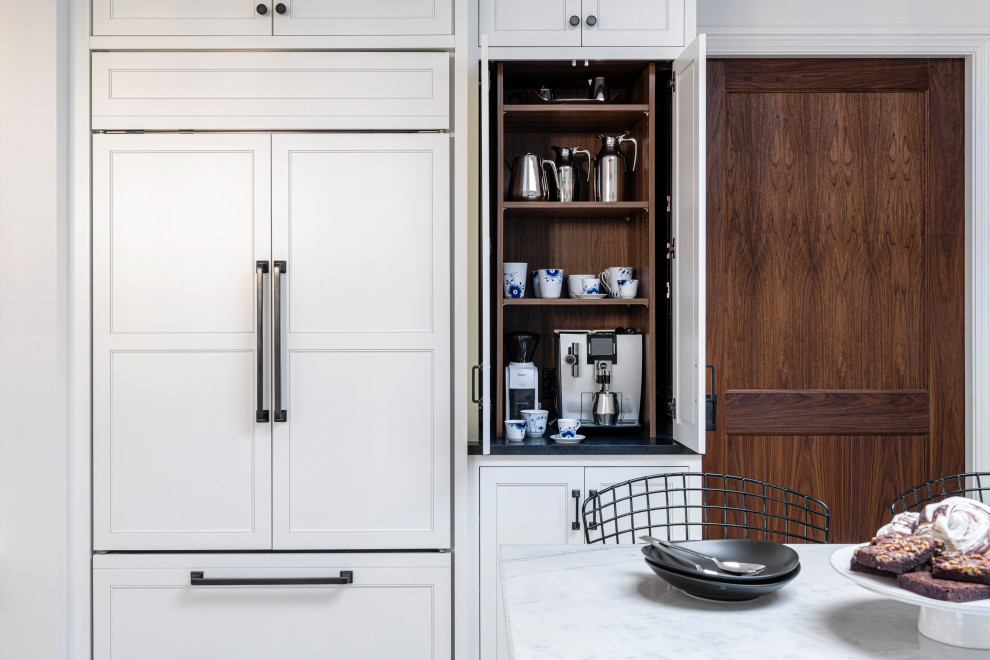 This is an example of a scandinavian kitchen pantry in Boston with shaker cabinets, white cabinets and an island.