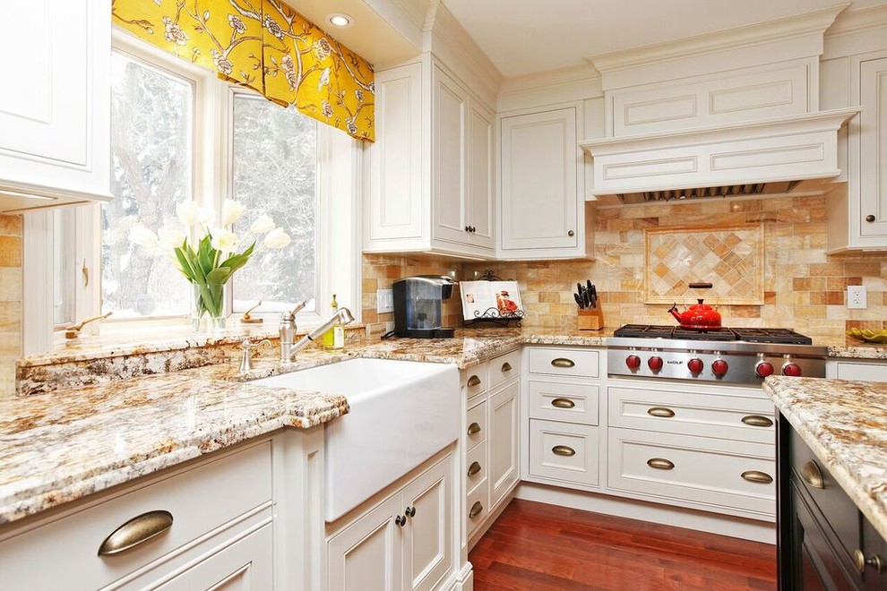 Example of a large transitional u-shaped medium tone wood floor and brown floor eat-in kitchen design in Toronto with a farmhouse sink, raised-panel cabinets, granite countertops, yellow backsplash, marble backsplash, paneled appliances and an island
