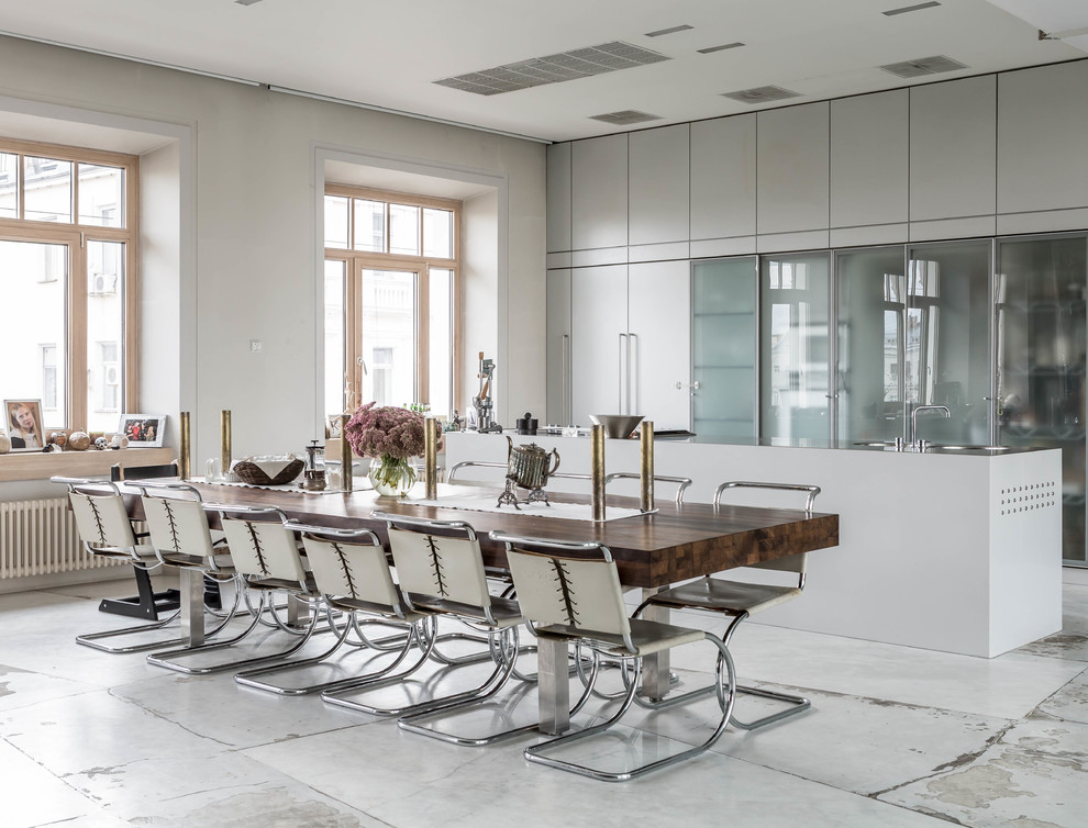 Contemporary dining room in Moscow with white walls and grey floor.