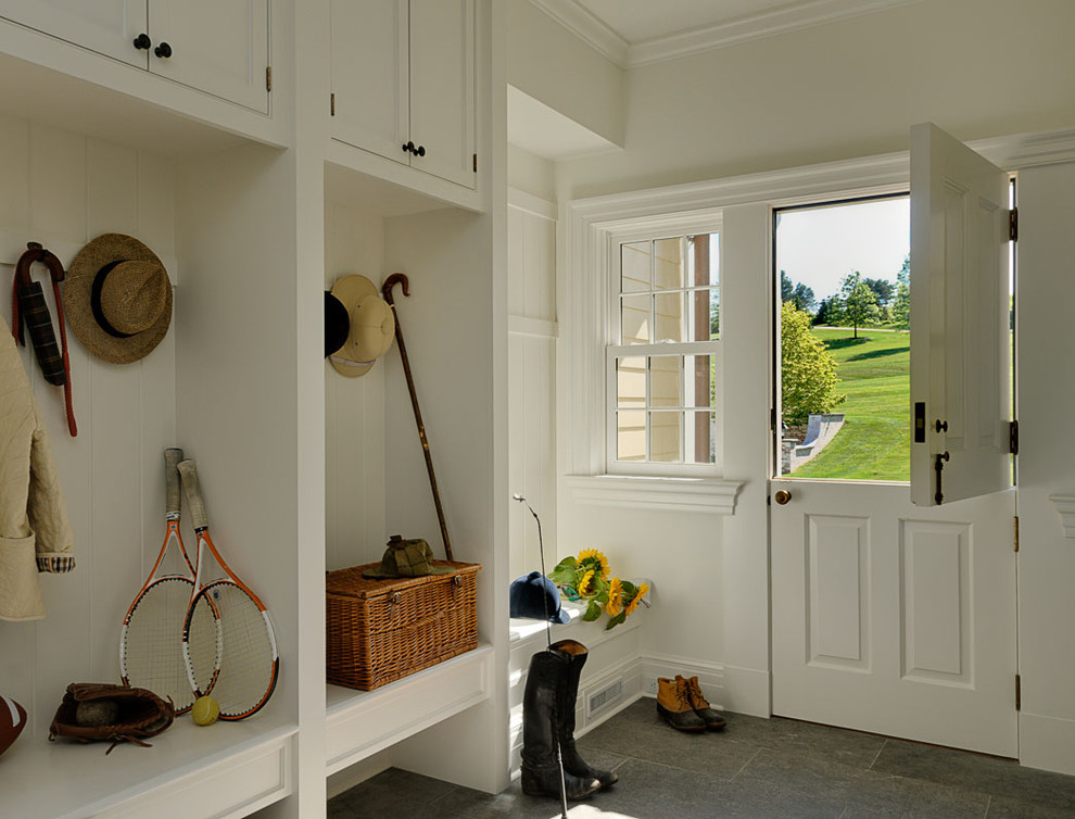 This is an example of a traditional entryway in New York with a dutch front door.