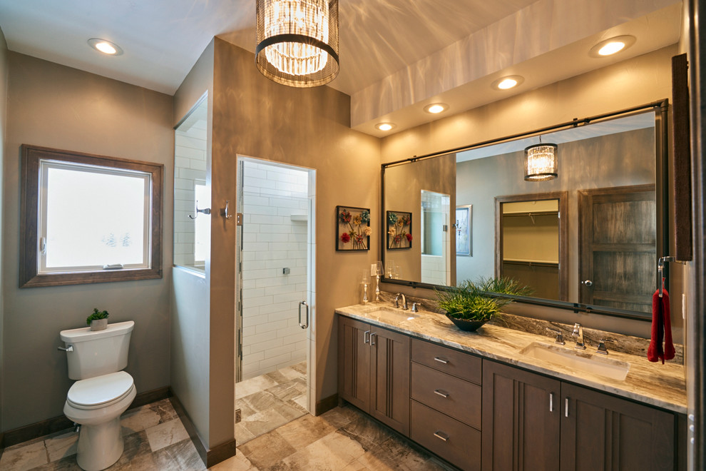 This is an example of a traditional master bathroom in Other with grey cabinets, multi-coloured tile, granite benchtops, a freestanding tub, an alcove shower, a two-piece toilet, subway tile, beige walls, slate floors, an undermount sink, beige floor and a hinged shower door.