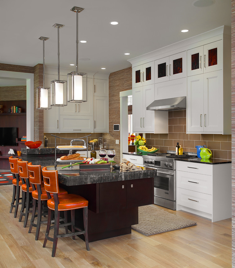 Inspiration for a large transitional eat-in kitchen in Grand Rapids with a farmhouse sink, recessed-panel cabinets, white cabinets, granite benchtops, brown splashback, subway tile splashback, stainless steel appliances, medium hardwood floors and with island.