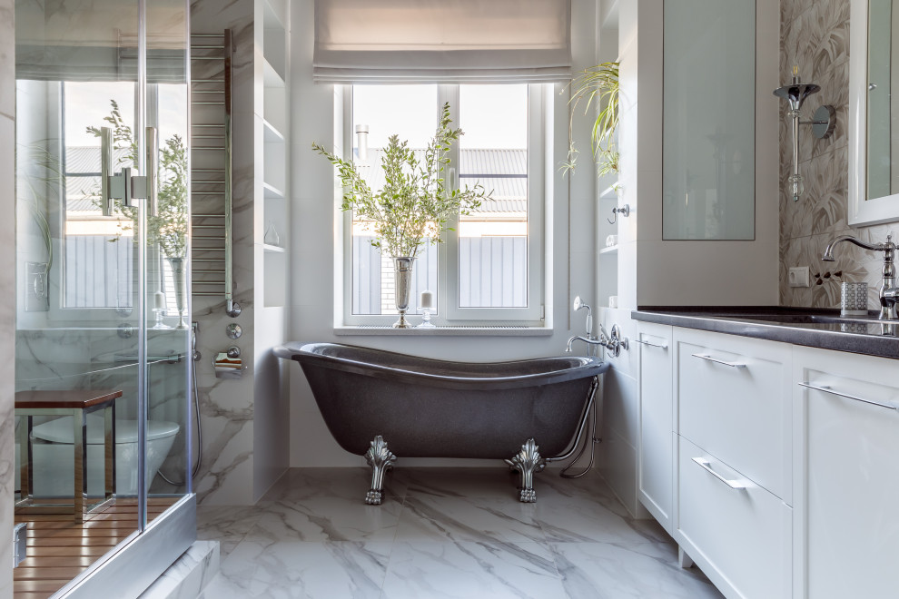 This is an example of a large transitional bathroom in Other with shaker cabinets, white cabinets, a claw-foot tub, a corner shower, white tile, white walls, an undermount sink, white floor, grey benchtops and a built-in vanity.