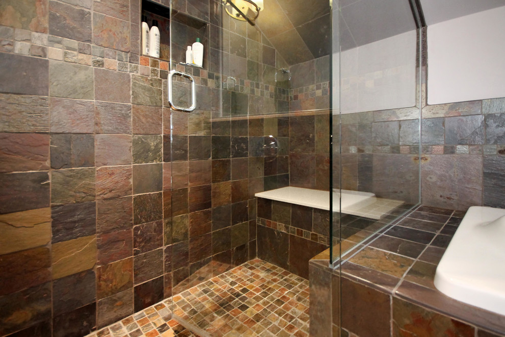 Photo of a large traditional master bathroom in Other with flat-panel cabinets, black cabinets, a drop-in tub, a corner shower, multi-coloured tile, white walls, medium hardwood floors, an undermount sink and a hinged shower door.