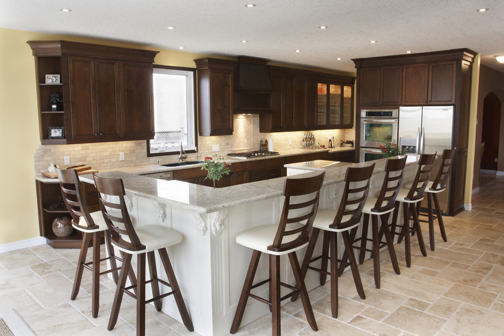 Inspiration for a traditional l-shaped eat-in kitchen in Toronto with an undermount sink, recessed-panel cabinets, dark wood cabinets, quartz benchtops, beige splashback, stone tile splashback and stainless steel appliances.