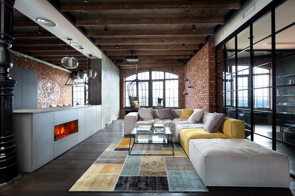 Design ideas for an industrial open concept living room in Other with dark hardwood floors and a ribbon fireplace.