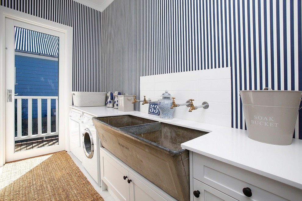 Small country single-wall dedicated laundry room in Other with a farmhouse sink, shaker cabinets, white cabinets, multi-coloured walls, ceramic floors, a side-by-side washer and dryer, white floor and white benchtop.