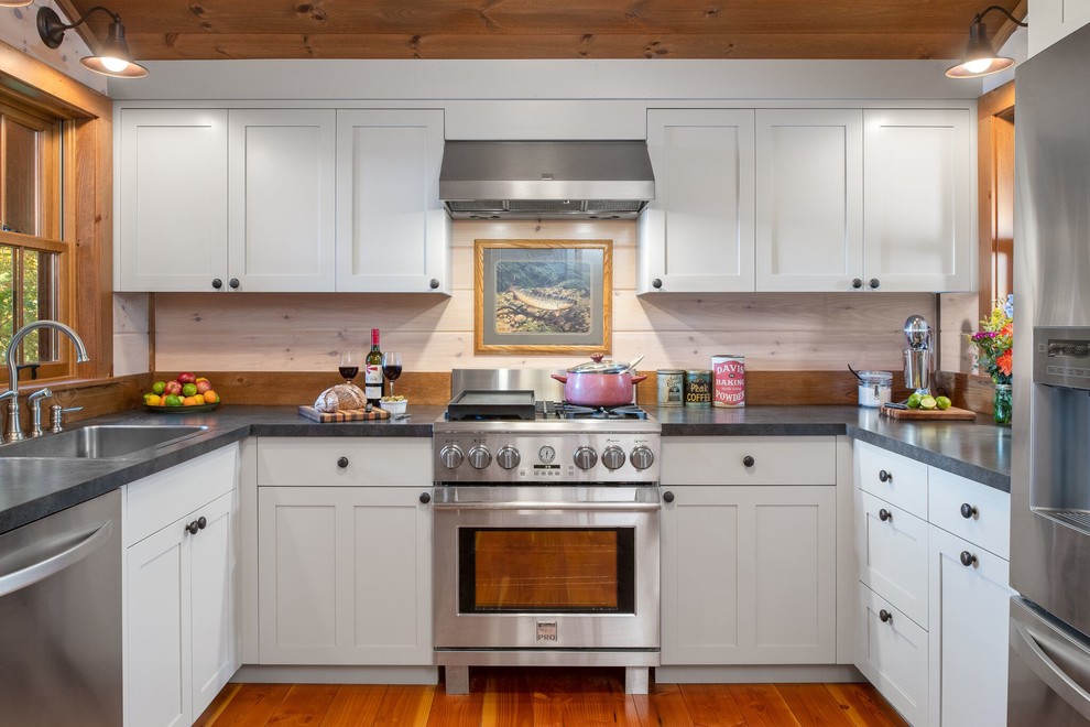 Inspiration for a country u-shaped kitchen in Burlington with a single-bowl sink, shaker cabinets, white cabinets, beige splashback, timber splashback, stainless steel appliances, medium hardwood floors and grey benchtop.