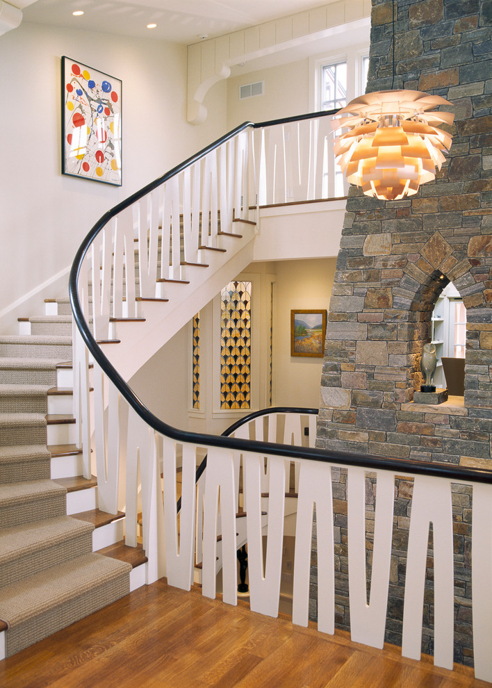 This is an example of a contemporary wood curved staircase in Boston.