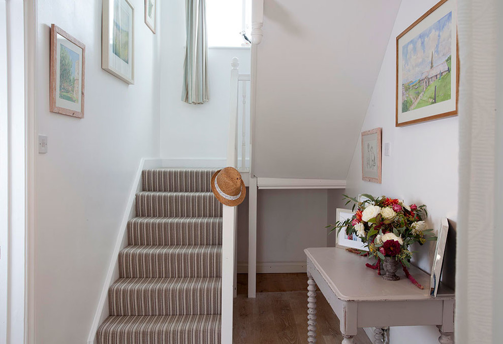 Inspiration for a small beach style hallway in Cornwall with white walls and medium hardwood floors.